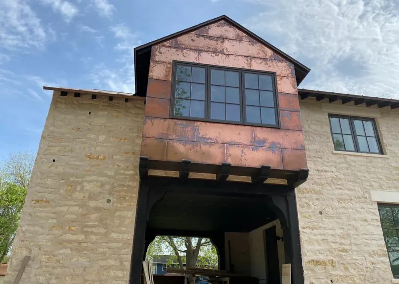Copper metal panel facade on a stone building for Skylight Installation in Spring Valley